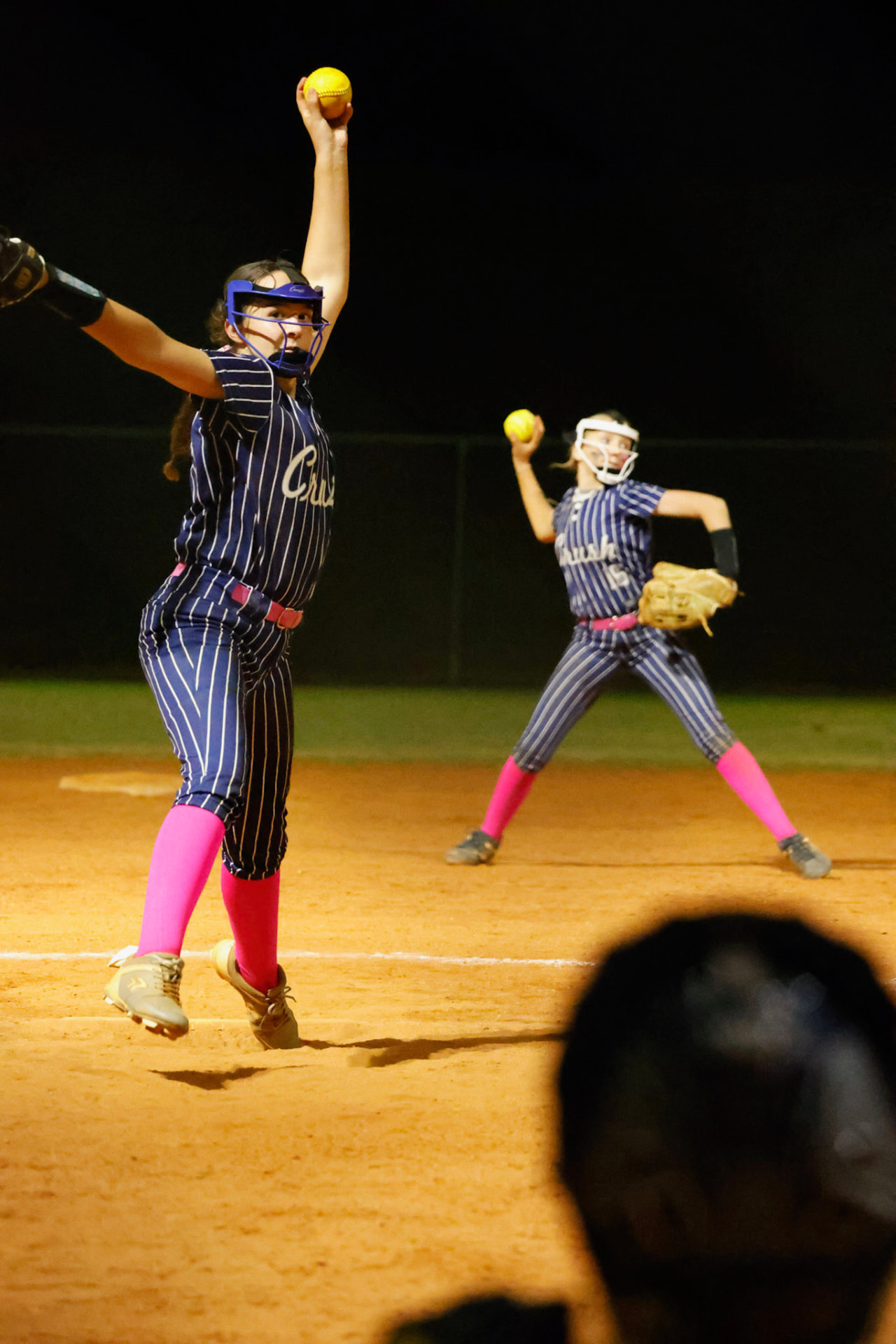 Pinstripes and pink socks under the lights.